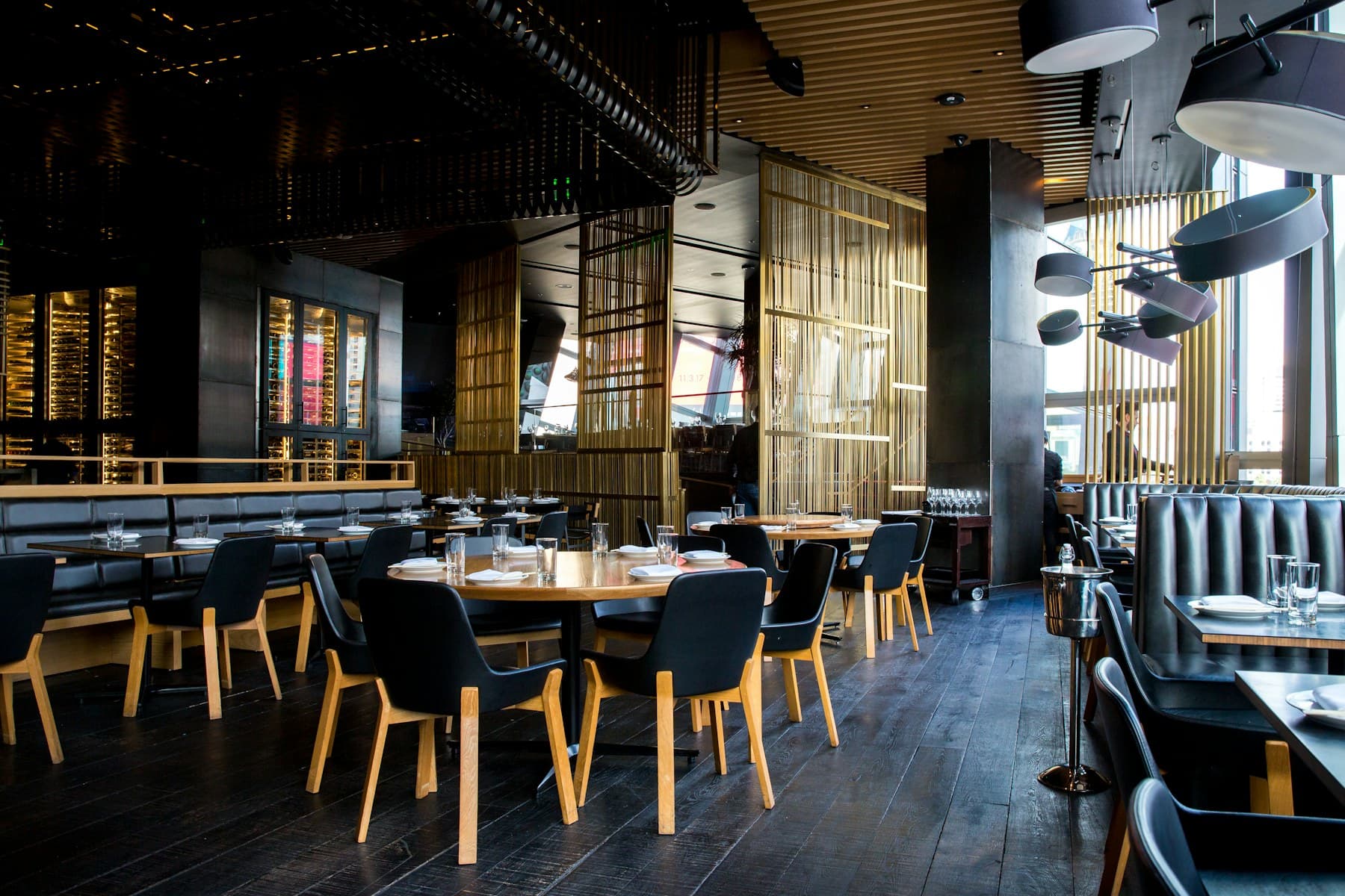 Warmly lit restaurant dining room with set tables